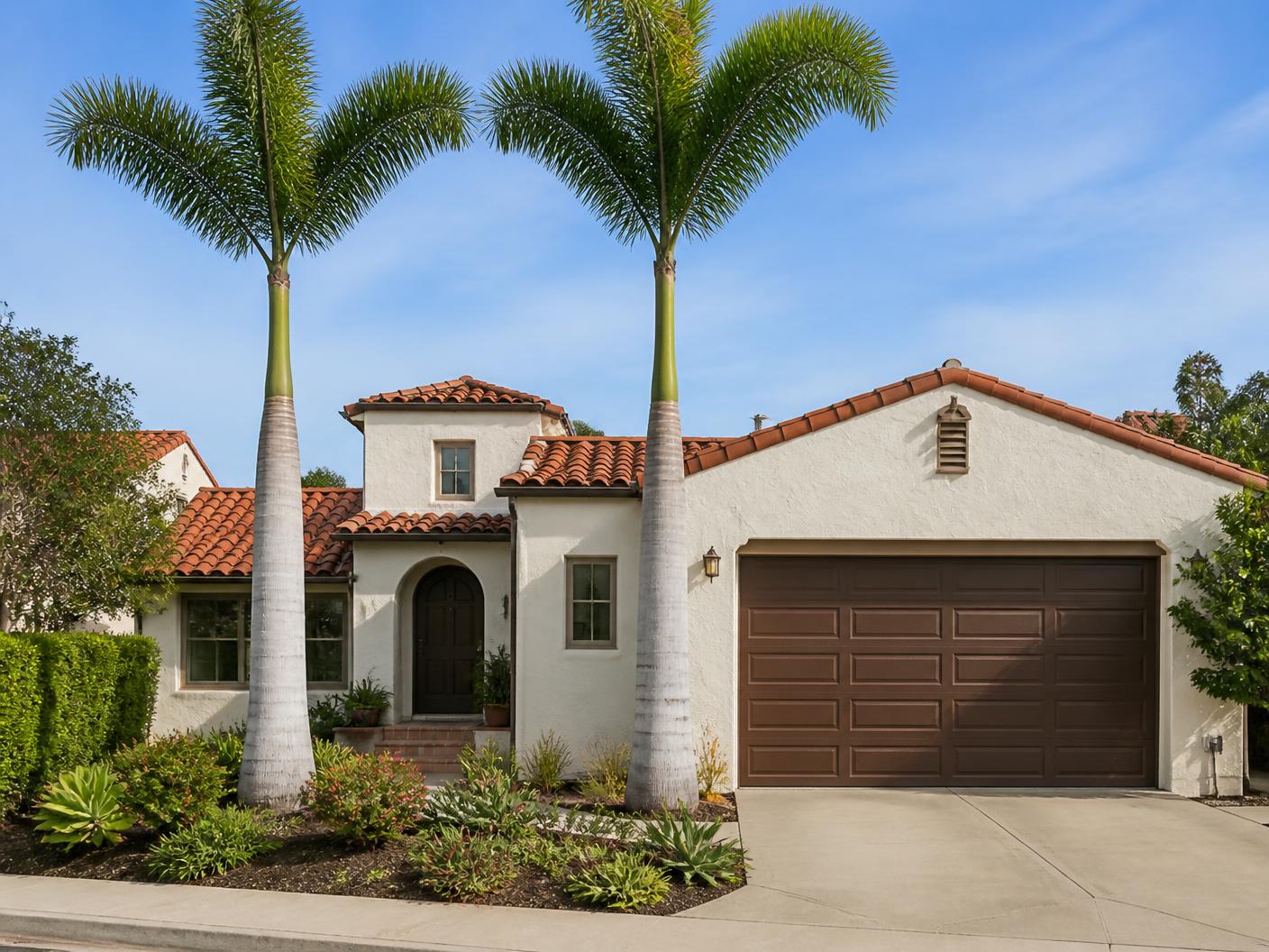 Queen palms trimmed and cleaned up in front of a Chula Vista home